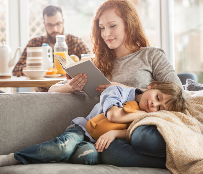 mother with son reading on couch